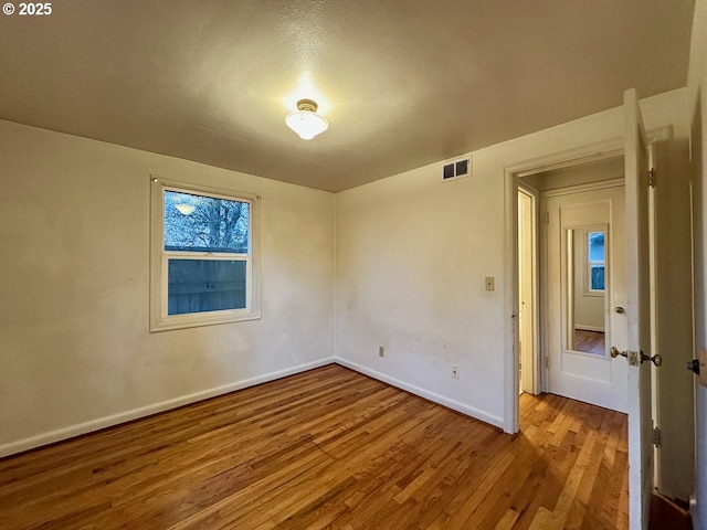 empty room featuring wood-type flooring