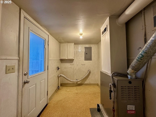 washroom featuring cabinets and electric panel