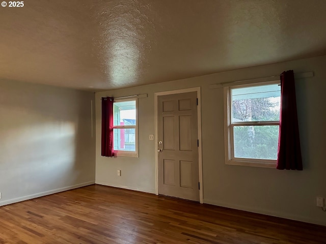 foyer entrance featuring hardwood / wood-style floors and a textured ceiling