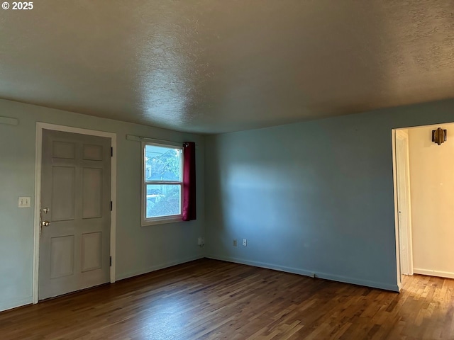 entryway with hardwood / wood-style flooring and a textured ceiling