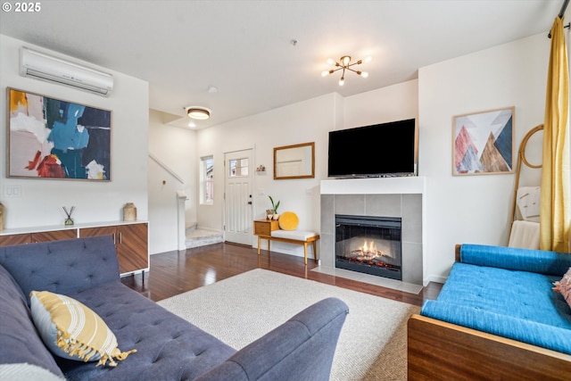 680 NW Falling Waters Ln Unit 105, Portland, OR 97229 - living room featuring a wall mounted air conditioner, wood finished floors, and a tiled fireplace