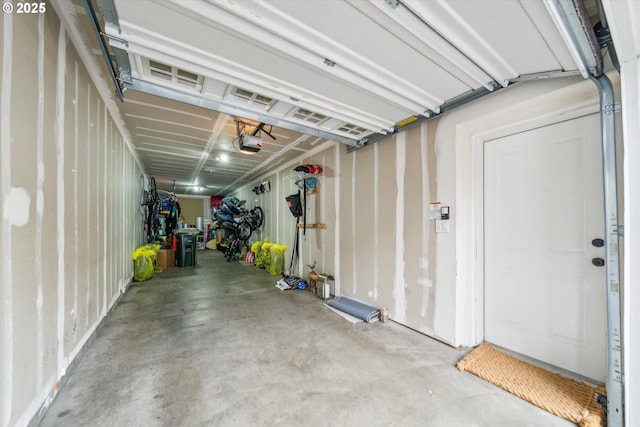 680 NW Falling Waters Ln Unit 105, Portland, OR 97229 - garage featuring a garage door opener