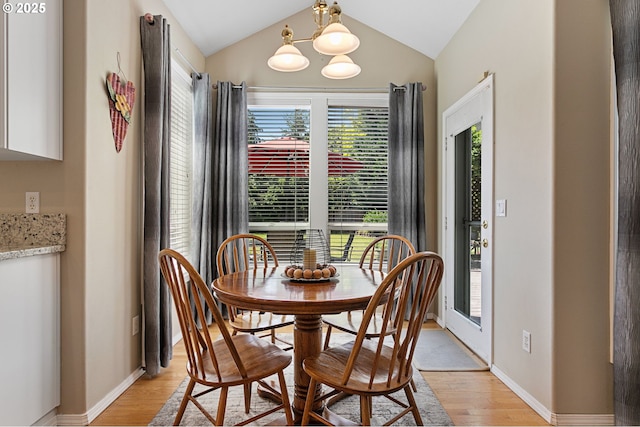 16295 NW Energia St, Portland, OR 97229 - dining space featuring light wood-style flooring, lofted ceiling, plenty of natural light, and a chandelier