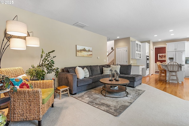 16295 NW Energia St, Portland, OR 97229 - living room featuring stairs, recessed lighting, and light wood-style floors