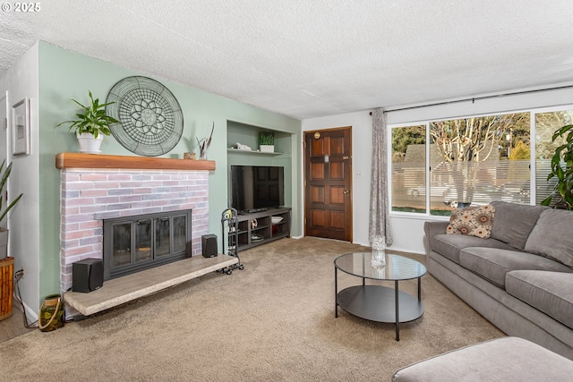 living room featuring built in shelves, a fireplace, a textured ceiling, and carpet flooring