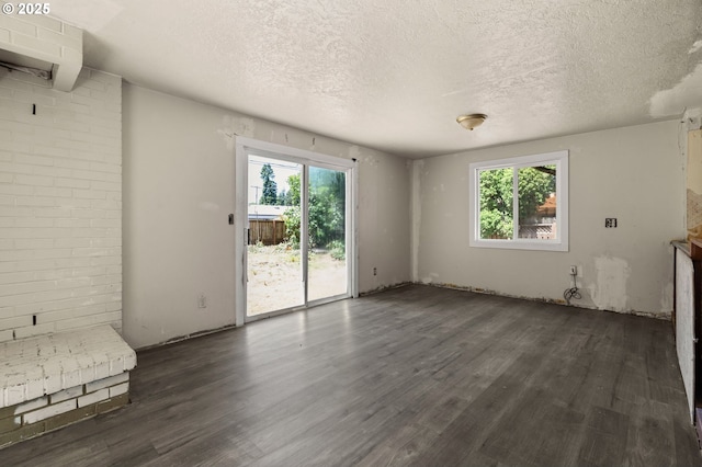 1203 NE 190th Pl, Portland, OR 97230 - unfurnished living room with dark wood-style flooring and a textured ceiling