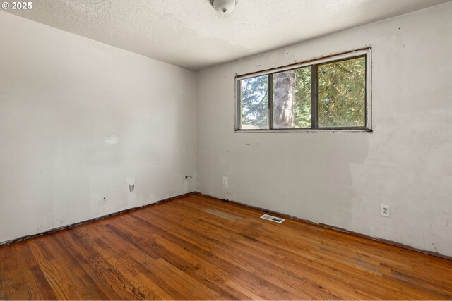 1203 NE 190th Pl, Portland, OR 97230 - spare room featuring wood finished floors and a textured ceiling