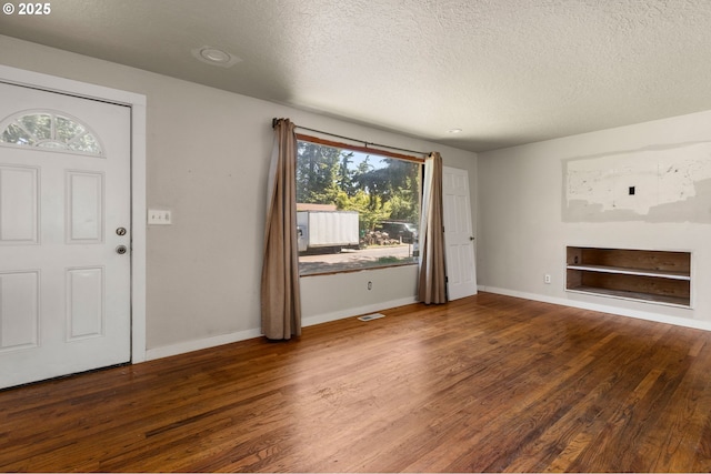 1203 NE 190th Pl, Portland, OR 97230 - entryway with a textured ceiling, wood finished floors, and baseboards