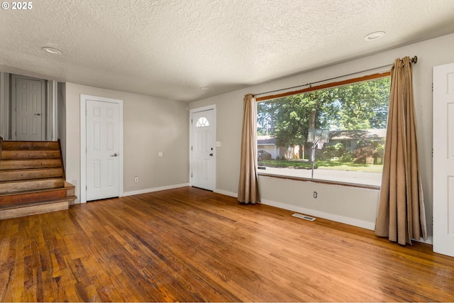 1203 NE 190th Pl, Portland, OR 97230 - foyer entrance with hardwood / wood-style flooring, a textured ceiling, stairway, and baseboards
