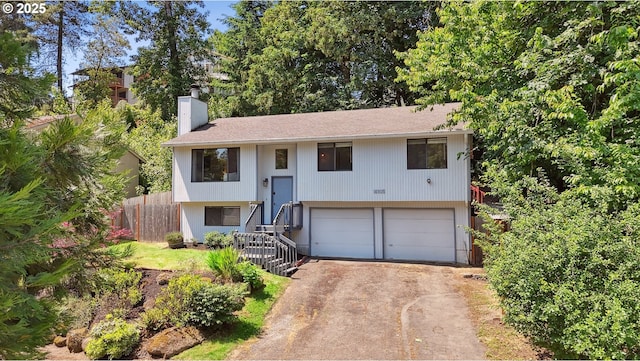 16905 Webster Rd, Gladstone, OR 97027 - split foyer home featuring a chimney, concrete driveway, and a garage