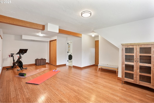 16905 Webster Rd, Gladstone, OR 97027 - exercise room featuring washer / clothes dryer, light wood-style flooring, and baseboards