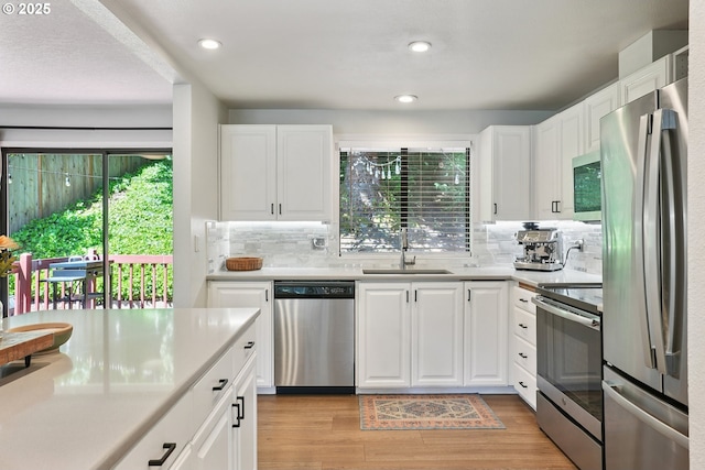 16905 Webster Rd, Gladstone, OR 97027 - kitchen featuring stainless steel appliances, light countertops, a sink, and recessed lighting