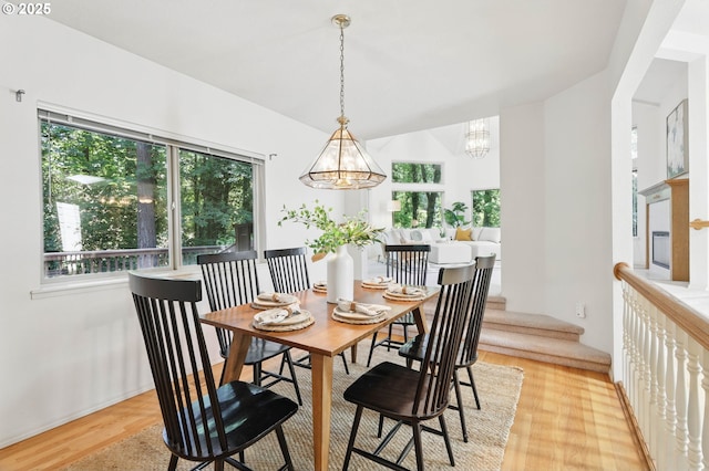 12028 SW Lesser Rd, Portland, OR 97219 - dining room featuring a chandelier and light wood-type flooring