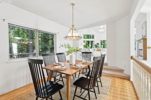 12028 SW Lesser Rd, Portland, OR 97219 - dining room with a chandelier and light wood-type flooring