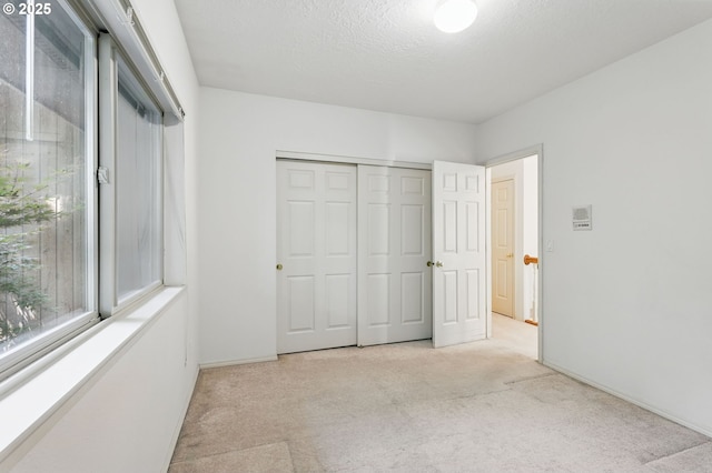 12028 SW Lesser Rd, Portland, OR 97219 - unfurnished bedroom featuring carpet, a closet, and baseboards