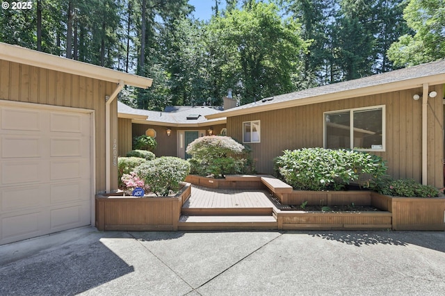 12028 SW Lesser Rd, Portland, OR 97219 - property entrance featuring an attached garage and driveway
