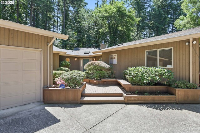 12028 SW Lesser Rd, Portland, OR 97219 - entrance to property featuring a garage and concrete driveway