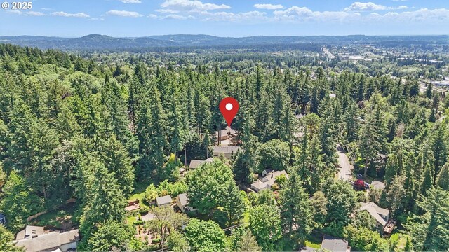12028 SW Lesser Rd, Portland, OR 97219 - aerial view of property and surrounding area featuring a heavily wooded area and mountains