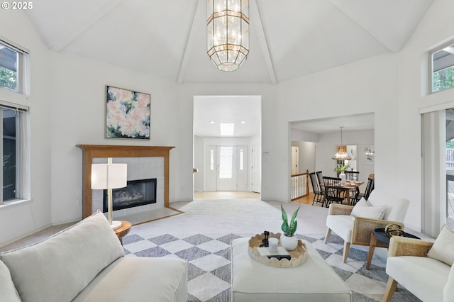 12028 SW Lesser Rd, Portland, OR 97219 - living area with a chandelier, high vaulted ceiling, a fireplace, and beam ceiling