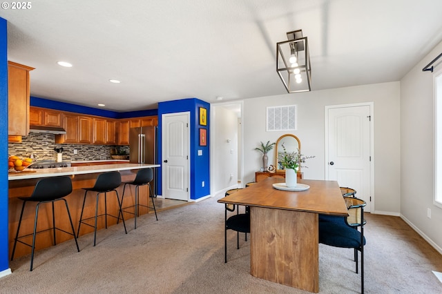dining space with light colored carpet, baseboards, and recessed lighting