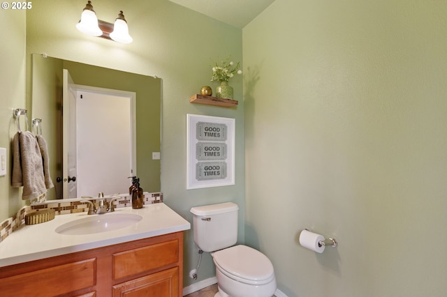 bathroom featuring toilet and vanity