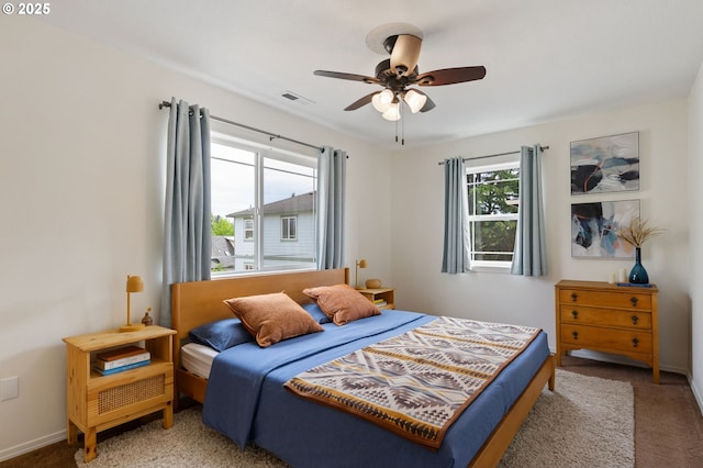 bedroom featuring carpet floors, ceiling fan, and baseboards