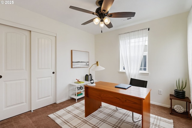 office space with ceiling fan, carpet floors, and baseboards