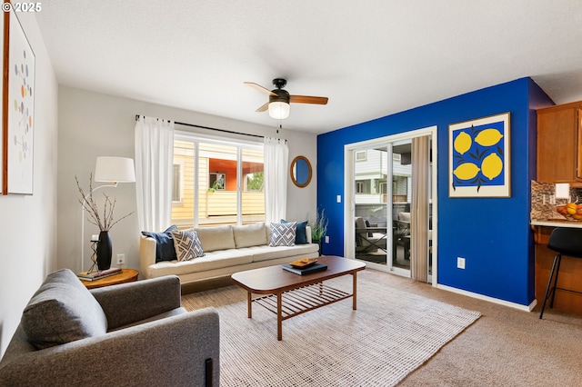living room with ceiling fan and light colored carpet