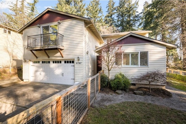 view of front of property featuring a garage and a balcony