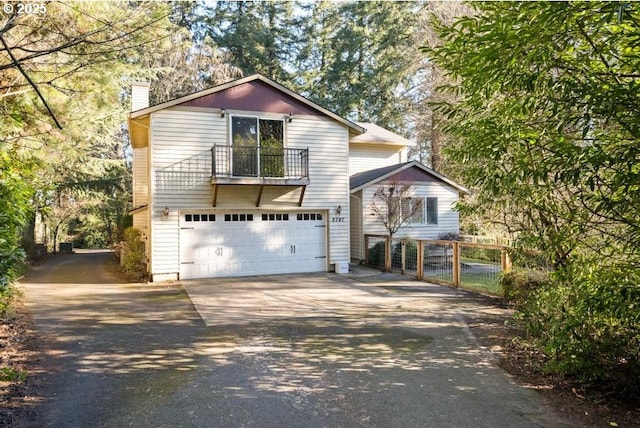 view of property featuring a garage and a balcony