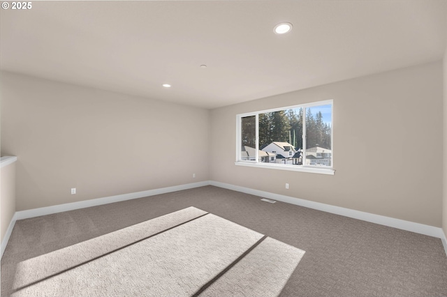 carpeted spare room with recessed lighting and baseboards