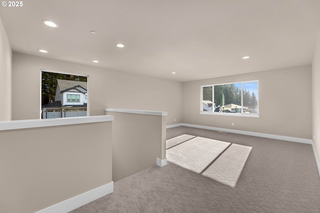carpeted empty room with baseboards and recessed lighting