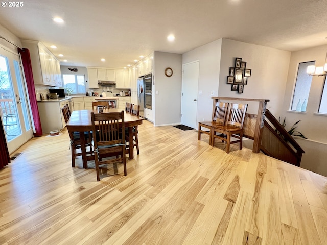 dining area with light wood-style flooring, baseboards, a notable chandelier, and recessed lighting