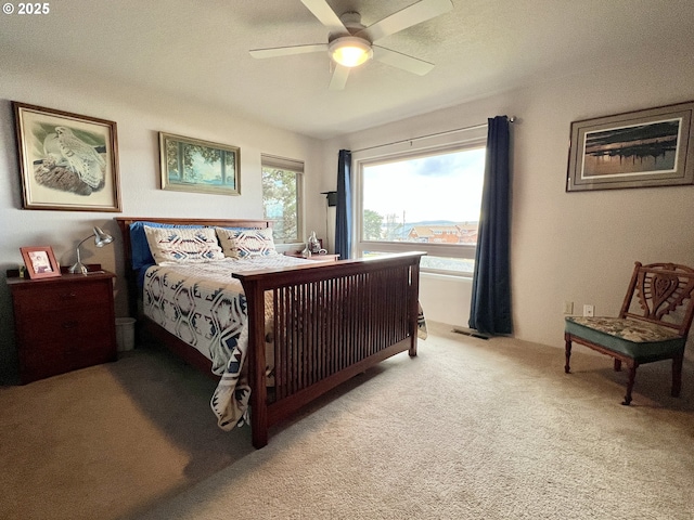 bedroom with a ceiling fan, visible vents, and carpet flooring
