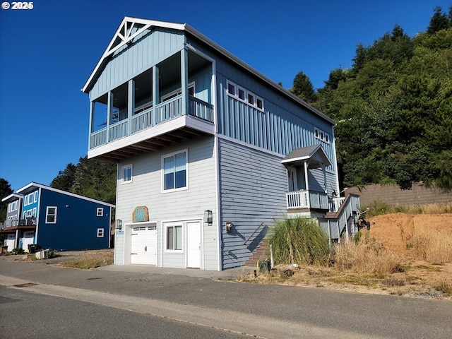 view of front of property featuring a garage and a balcony