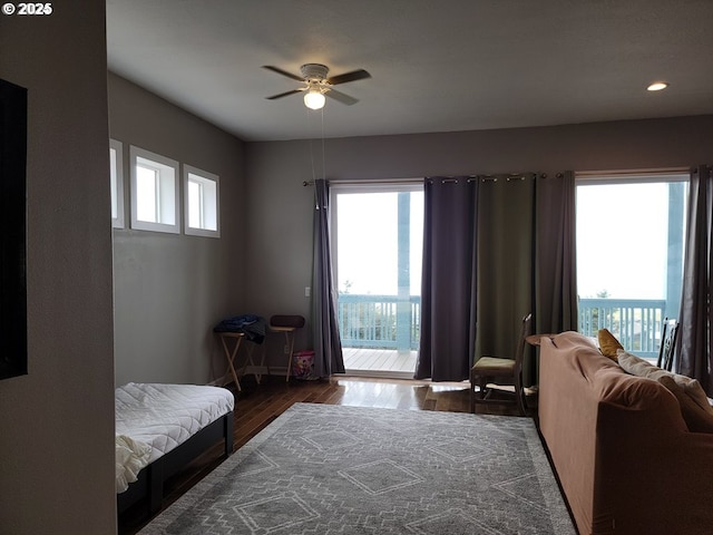 bedroom with dark hardwood / wood-style flooring, access to outside, and ceiling fan