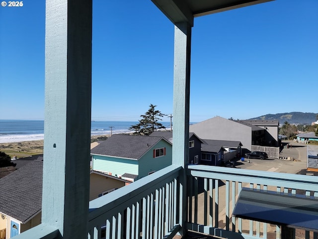 balcony featuring a water view and a beach view