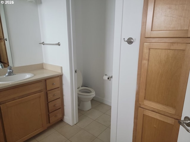 bathroom featuring tile patterned floors, toilet, and vanity