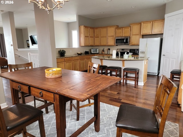 dining room featuring an inviting chandelier and hardwood / wood-style floors