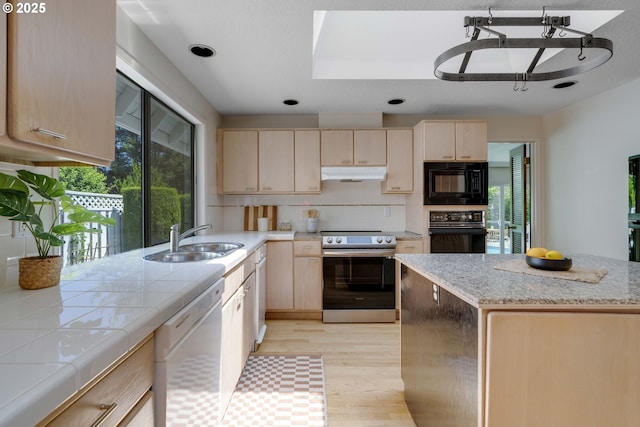 17141 Hofer Ct, Lake Oswego, OR 97034 - kitchen with black appliances, light brown cabinetry, under cabinet range hood, and light wood-style floors