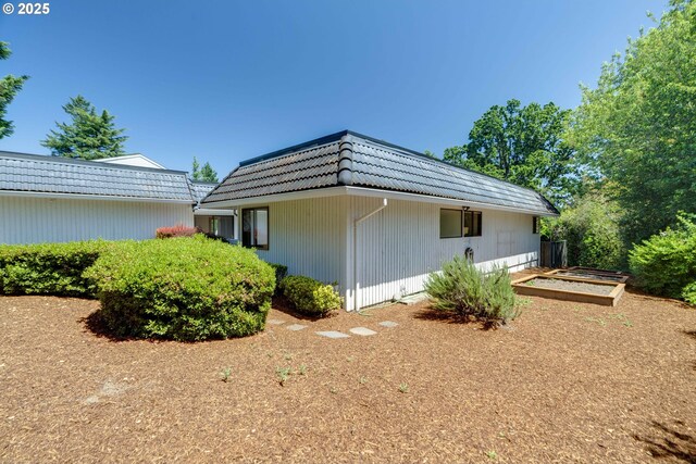 17141 Hofer Ct, Lake Oswego, OR 97034 - view of side of property featuring a garden, a tiled roof, and mansard roof