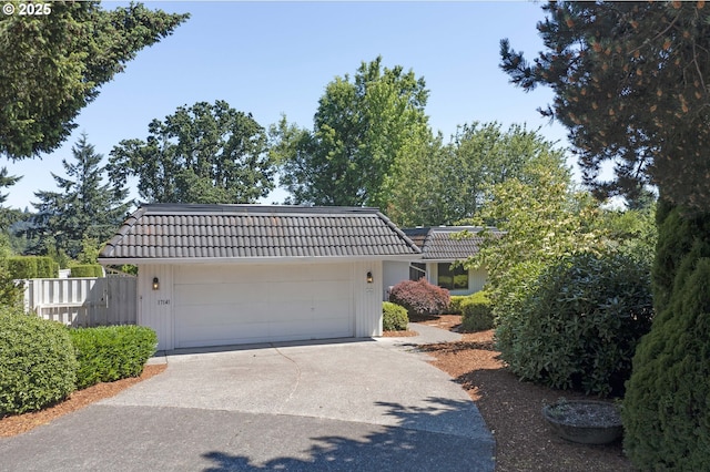 17141 Hofer Ct, Lake Oswego, OR 97034 - view of front of home featuring a tiled roof, concrete driveway, an attached garage, and mansard roof