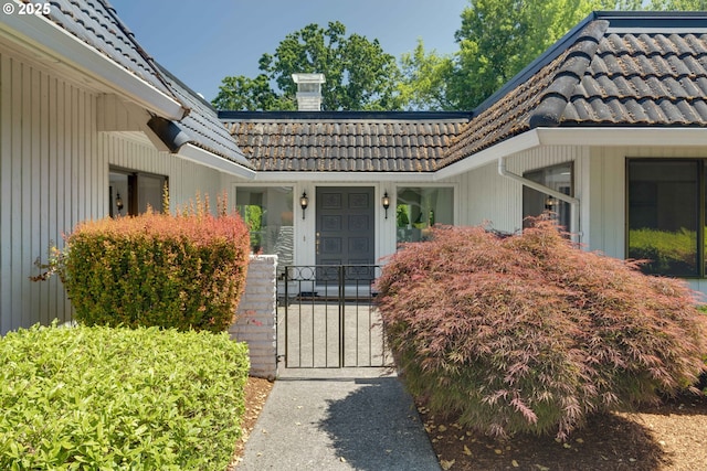 17141 Hofer Ct, Lake Oswego, OR 97034 - doorway to property with a tile roof, a chimney, and a gate