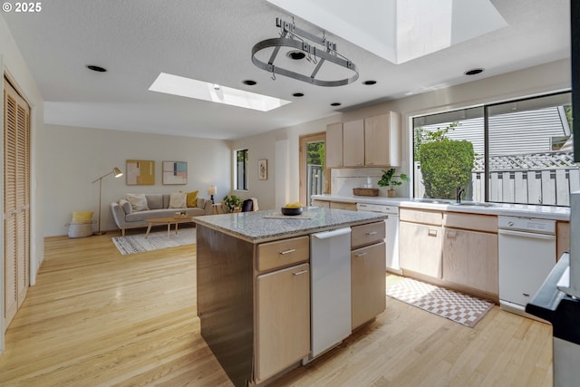 17141 Hofer Ct, Lake Oswego, OR 97034 - kitchen with a skylight, dishwasher, light wood finished floors, a kitchen island, and light brown cabinetry
