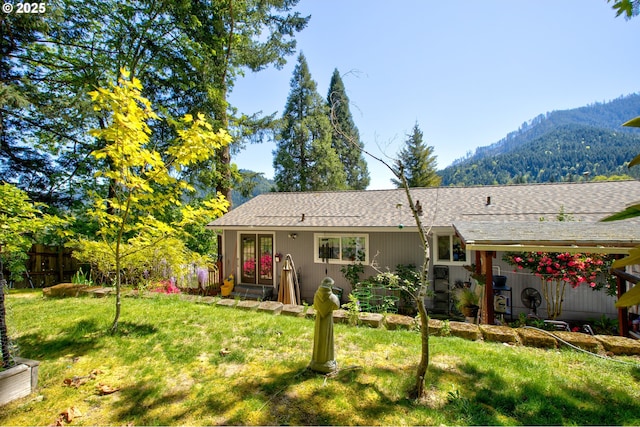 590 Fairchild St, Canyonville, OR 97417 - back of house featuring a mountain view, a lawn, and a shingled roof