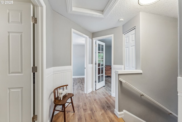 17948 SW Robert Ln, Beaverton, OR 97078 - corridor with light wood finished floors, a textured ceiling, and a wainscoted wall