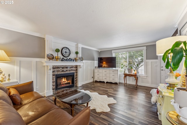 17948 SW Robert Ln, Beaverton, OR 97078 - living room with a decorative wall, a stone fireplace, ornamental molding, wood finished floors, and a wainscoted wall