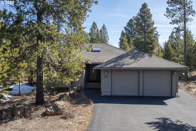18144 Maury Mountain Ln, Sunriver, OR 97707 - view of front of property featuring a shingled roof, an attached garage, and driveway
