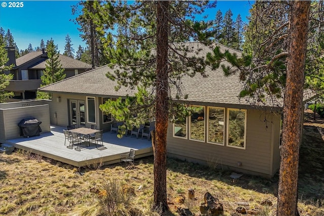 18144 Maury Mountain Ln, Sunriver, OR 97707 - rear view of property with a shingled roof, a wooden deck, and french doors