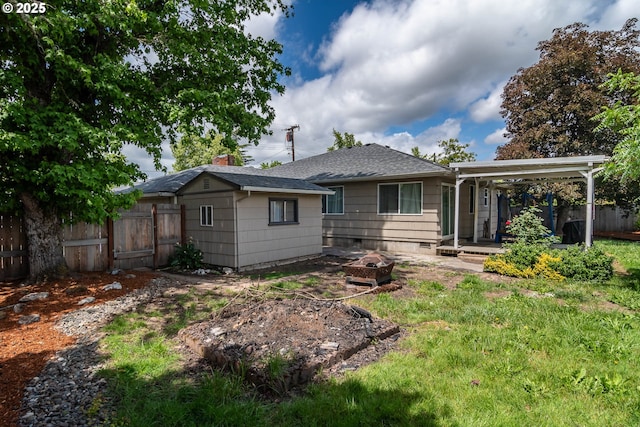 4033 Hanna St, Roseburg, OR 97471 - rear view of house featuring a fire pit, roof with shingles, an outdoor structure, and a chimney